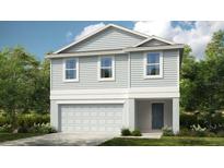 Two-story house with gray siding, two-car garage, and landscaping at 4607 Snapdragon Pl, Lake Hamilton, FL 33851