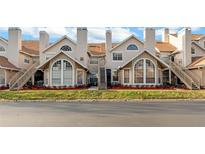 Tan two-story townhouses with brown roofs, stairs, and landscaping at 605 Youngstown Pkwy # 32, Altamonte Springs, FL 32714