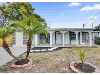 Newly renovated home with a welcoming front porch and landscaping at 923 Ferndell Rd, Orlando, FL 32808