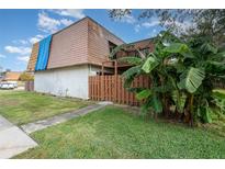 Two-story condo building with brown roof and wooden fence at 95 Moonstone Ct, Port Orange, FL 32129