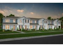 Modern townhome community with attached garages and landscaped yards at 11175 Rising Sun St, Orlando, FL 32829