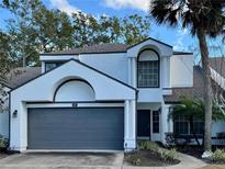 Two-story house with gray garage door and white exterior at 121 Wimbledon Cir, Lake Mary, FL 32746