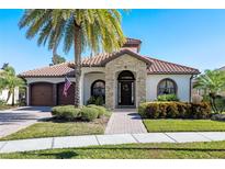 Inviting one-story home with stone accents and lush landscaping at 12435 Montalcino Cir, Windermere, FL 34786