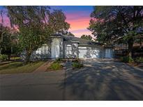 Beautiful one-story home with a landscaped yard and two-car garage at 2061 Petit Ct, Apopka, FL 32712