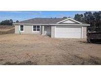 New construction featuring a two car garage and light gray exterior at 238 Locust Rd, Ocala, FL 34472