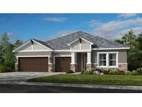 Two-story home with brown double garage doors and gray siding at 2995 Arranmore Dr, Ormond Beach, FL 32174