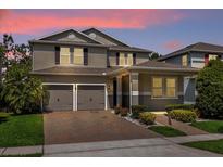 Two-story house with a two-car garage and landscaped front yard at 8060 Bowery Dr, Winter Garden, FL 34787