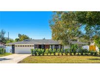 Updated mid-century modern home with landscaped yard and attached two-car garage at 1509 Oxford Rd, Maitland, FL 32751