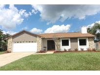 Updated single-story home with a stone facade and a two-car garage at 1710 Aster Dr, Winter Park, FL 32792