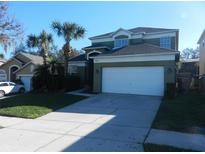 Inviting two-story home with a well-maintained lawn and a spacious two-car garage at 2803 Lido Key Ct, Kissimmee, FL 34747