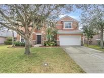 Two-story house with stone accents and a large front yard at 351 Michigan Estates Cir, St Cloud, FL 34769