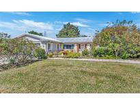 Ranch-style home with mature landscaping and a spacious yard at 4437 Elaine Pl, Orlando, FL 32812