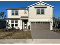 Two-story house with brown garage door and light beige exterior at 5425 Log Grove Ln, Orlando, FL 32829