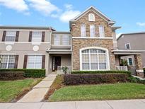 Two-story townhome with stone accents and landscaping at 2250 Park Maitland Ct, Maitland, FL 32751