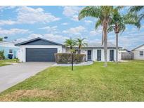 Updated home exterior boasts a modern design, fresh landscaping, and a spacious driveway at 2932 Carriage Dr, Daytona Beach, FL 32119
