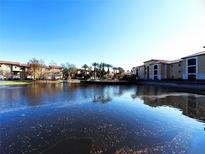 Waterfront community view with palm trees and Spanish-style buildings at 6149 Metrowest Blvd # 106, Orlando, FL 32835