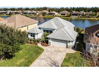 Single-Gathering home with a paved driveway and a lake view in a quiet neighborhood at 7836 Crosswinds Way, Mount Dora, FL 32757