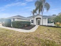 Single-story home with a landscaped yard and palm trees at 1878 Algonquin Ave, Deltona, FL 32725