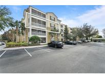 Condo building with parking lot and landscaping at 3362 Robert Trent Jones Dr # 30307, Orlando, FL 32835