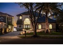 Stunning two-story home at night with elegant entryway at 8010 Firenze Blvd, Orlando, FL 32836