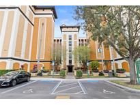 Exterior of building with parking and landscaping at 12527 Floridays Resort Dr # E102, Orlando, FL 32821