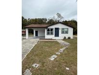 Newly renovated home with a modern exterior, driveway, and landscaped yard at 1821 Rogers Ave, Maitland, FL 32751