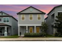 Two-story house with gray siding, front porch, and landscaping at 1997 Standing Rock Cir, Oakland, FL 34787