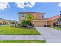 Two-story house with a two-car garage and nicely landscaped lawn at 2501 Dharma Cir, Kissimmee, FL 34746