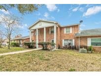 Front view of a brick building with landscaping at 5824 La Costa Dr, Orlando, FL 32807