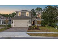 Charming two-story home with a well-manicured lawn, lovely landscaping, and a spacious two car garage at 223 Cherokee Hill, Deland, FL 32724