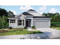 Charming single-Gathering home showcasing stone accents, a two-car garage, and a well-maintained lawn at 25122 Ensley Rd, Sorrento, FL 32776