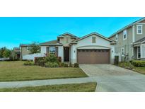 One-story home with brown garage door and landscaped front yard at 2232 Donahue Dr, Ocoee, FL 34761