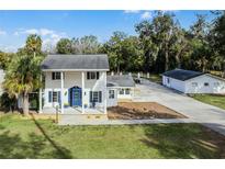 Aerial view of a charming house with a pool and detached garage at 5703 Se 109Th St, Belleview, FL 34420