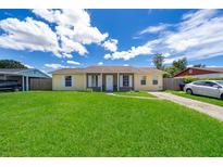 Ranch-style home with a spacious lawn and driveway at 6655 Durango Ct, Orlando, FL 32809