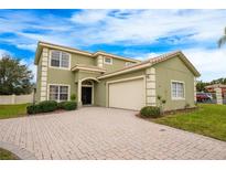 Two-story house with a large driveway and a two-car garage at 111 Vista Dr, Davenport, FL 33897