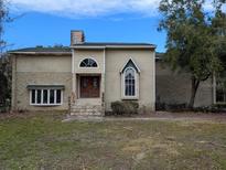 Two-story house with stone accents and a large front yard at 1450 Warrior Trl, Deltona, FL 32725