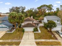Aerial view of a charming house with a spacious yard and driveway at 3545 S Saint Lucie Dr, Casselberry, FL 32707
