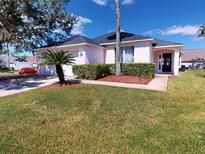 Cute one-story house with a two-car garage and well-manicured lawn at 4715 Ainsdale Walk, Kissimmee, FL 34746