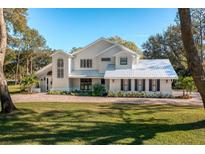 Stunning two-story home with metal roof and landscaped lawn at 11036 Schooner Way, Windermere, FL 34786