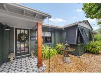Inviting front porch with patterned tile, wooden post, and a charming wreath at 1424 Cavendish Rd, Winter Park, FL 32789