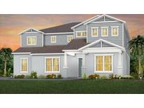 Two-story home with gray siding, multiple windows, and landscaping at 15359 Rising View Dr, Montverde, FL 34756