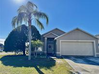 Single-story house with a two-car garage and palm tree in front at 2864 Copper Ridge Ct, Lake Mary, FL 32746