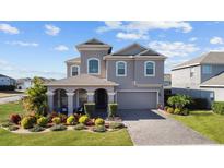 Charming two-story home with a paved driveway, two car garage, and a meticulously landscaped front yard at 998 Nathan Ridge Rd, Clermont, FL 34715