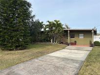 Green ranch house with a long driveway and mature landscaping at 3109 Surfside Way, Orlando, FL 32805