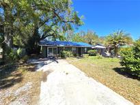 Charming single-story home featuring a spacious front yard, mature trees, and a long driveway leading to the entrance at 3421 Fudge Rd, Apopka, FL 32712