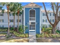 Condo building exterior with blue accents and landscaping at 4208 Clubside Dr # 4208, Longwood, FL 32779