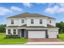 Beautiful two-story home featuring a three-car garage, landscaped yard, and a stone-accented facade at 5067 Northern Dove Ave, Mount Dora, FL 32757