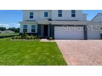 Charming two-story home with a well-manicured lawn at 5067 Northern Dove Ave, Mount Dora, FL 32757