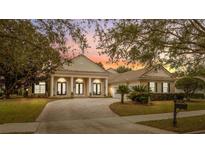 Beautiful two-story home with a brick driveway and manicured lawn at 6220 Cartmel Ln, Windermere, FL 34786