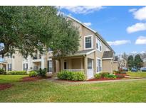 Inviting exterior of a two-story townhome with landscaping and a covered porch at 9125 Lee Vista Blvd # 706, Orlando, FL 32829